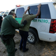 Border Patrol agents arresting two men near McAllen, Texas, along the U.S.-Mexico border.